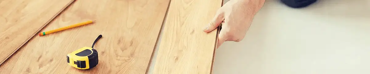 A professional installing wood flooring in Green Bay, WI