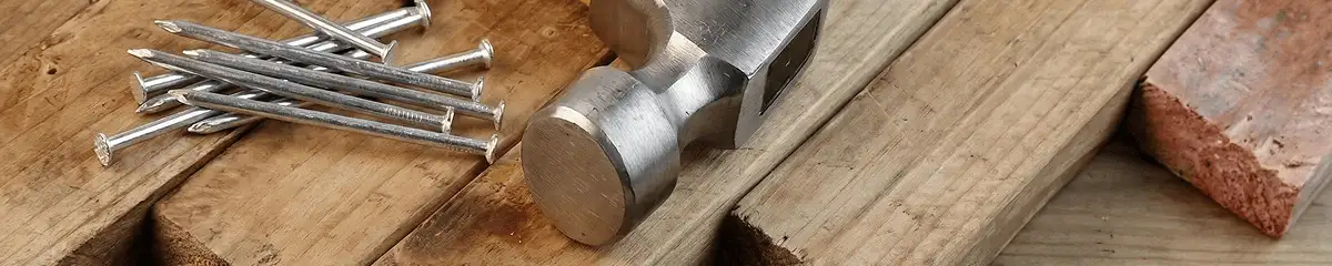 Hammer and nails on hardwood flooring boards in Green Bay, WI