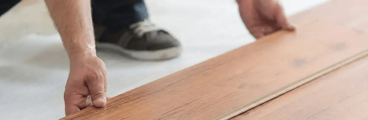 A professional installing laminate flooring in Green Bay, WI